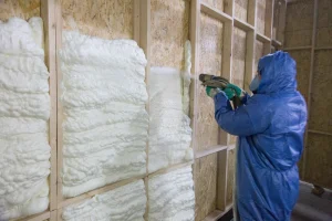 energysmith home performance professional sprays foam insulation in wall