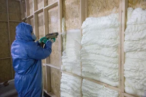 energysmith home performance professional sprays foam insulation in wall